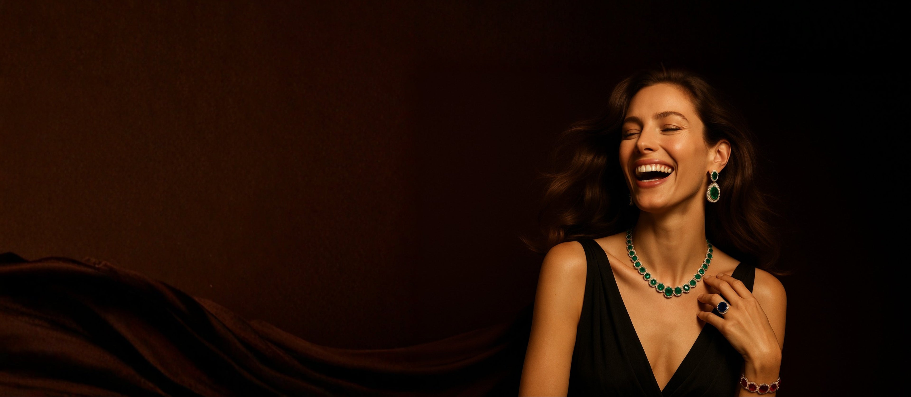 Woman wearing a black dress and green necklace against a dark background